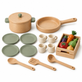 Alder wood play kitchen set with pot, pan, sage plates, cream cups, utensils and a crate of play vegetables on white