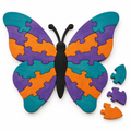 Large wooden butterfly jigsaw in teal, violet and orange, nearly complete with loose pieces, on white